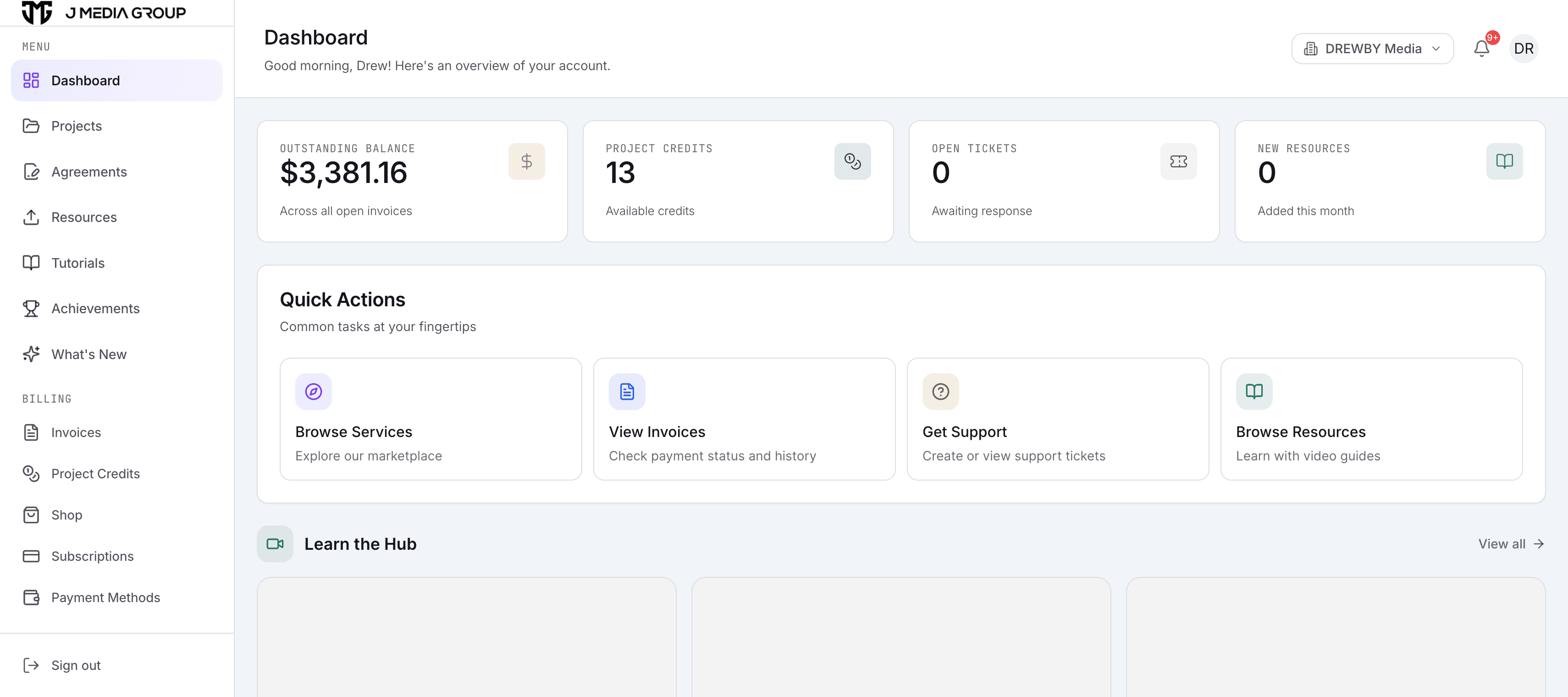 The JMG Hub client dashboard, showing outstanding balance, project credits, open support tickets, and quick actions for services, invoices, support, and resources.